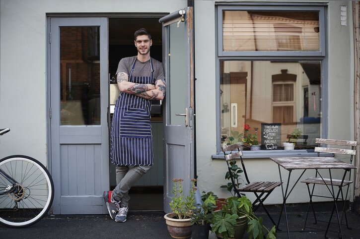 Portrait of young male cafe owner